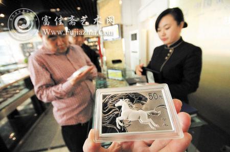 马年金银纪念币陆续面世，图为收藏爱好者在咨询。IC图